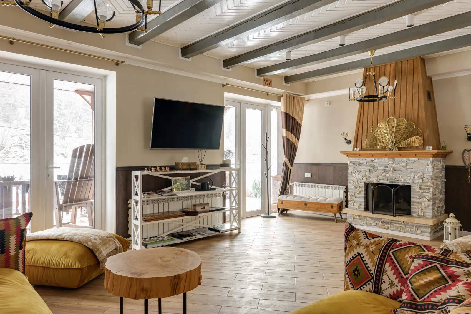 Wohnbereich eines Chalets mit Holzdecke und warmen Naturmaterialien